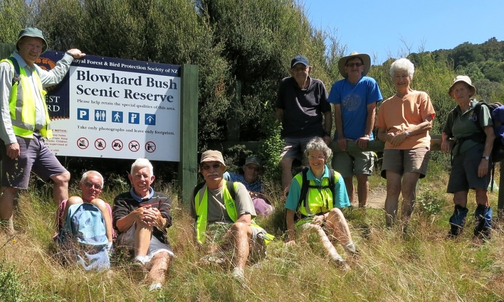 Volunteers standing by the Blowhard Bush Reserve sign