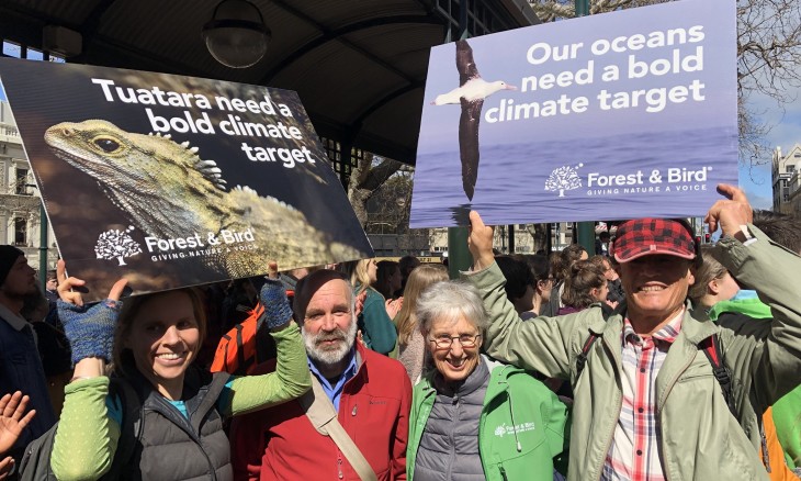 Forest and Bird Dunedin members hold up signs at the School Strike for Climate in Dunedin