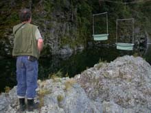 Brian inspecting harp-traps suspended over the Pelorus River
