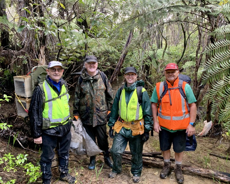 Pest Free Hibiscus Coast volunteers (from left) Gordon Whitelaw, Kelvin Hempseed, and Alan Wilkinson with Forest & Bird’s field operations lead Naomi Harrison. Credit Jenny Hanwell